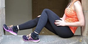 A woman sitting on the steps of a building.