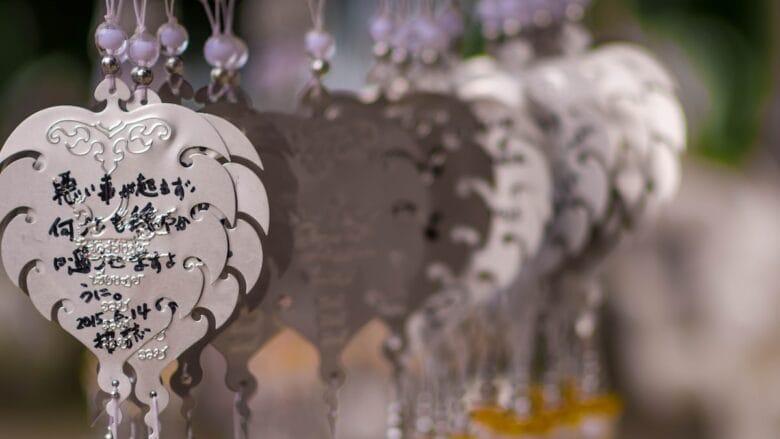 A group of chinese charms hanging from a string.