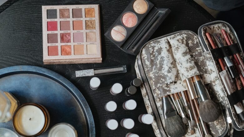 Makeup brushes and cosmetics on a table.